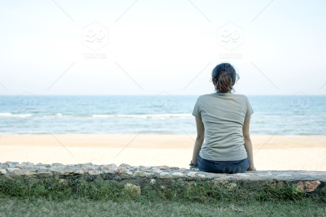stock-photo-sea-beach-sand-sitting-woman-alone-lonely-sad-thinking-28a84bf2-6e3e-442b-b930-2404a38df06e